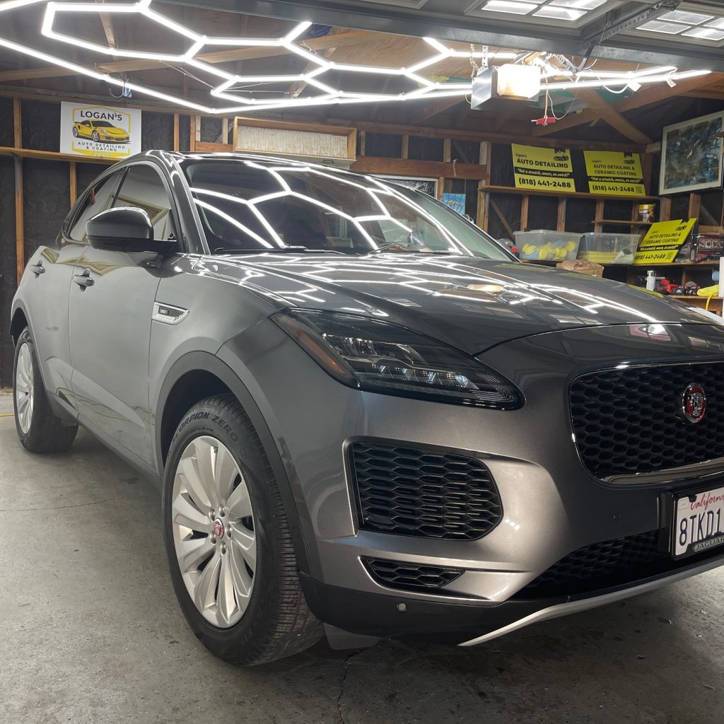 A professional detailing team working on a car in Sherman Village