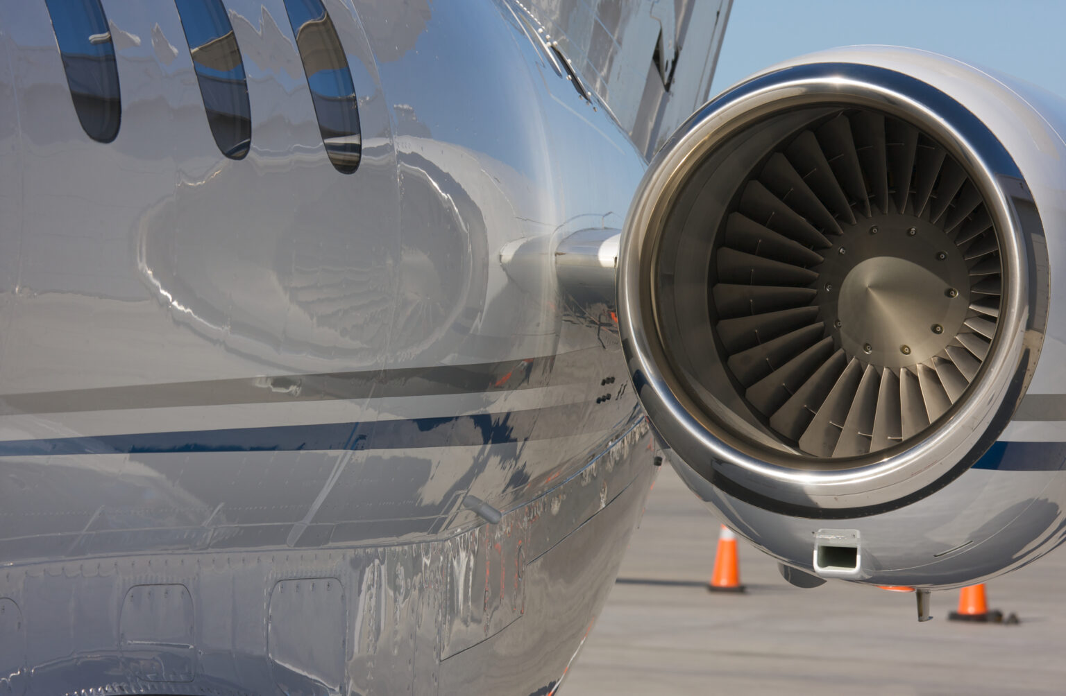 Private jet engine nacelle and polished fuselage — brightwork and exhaust staining are two of the biggest cost drivers in aircraft detailing