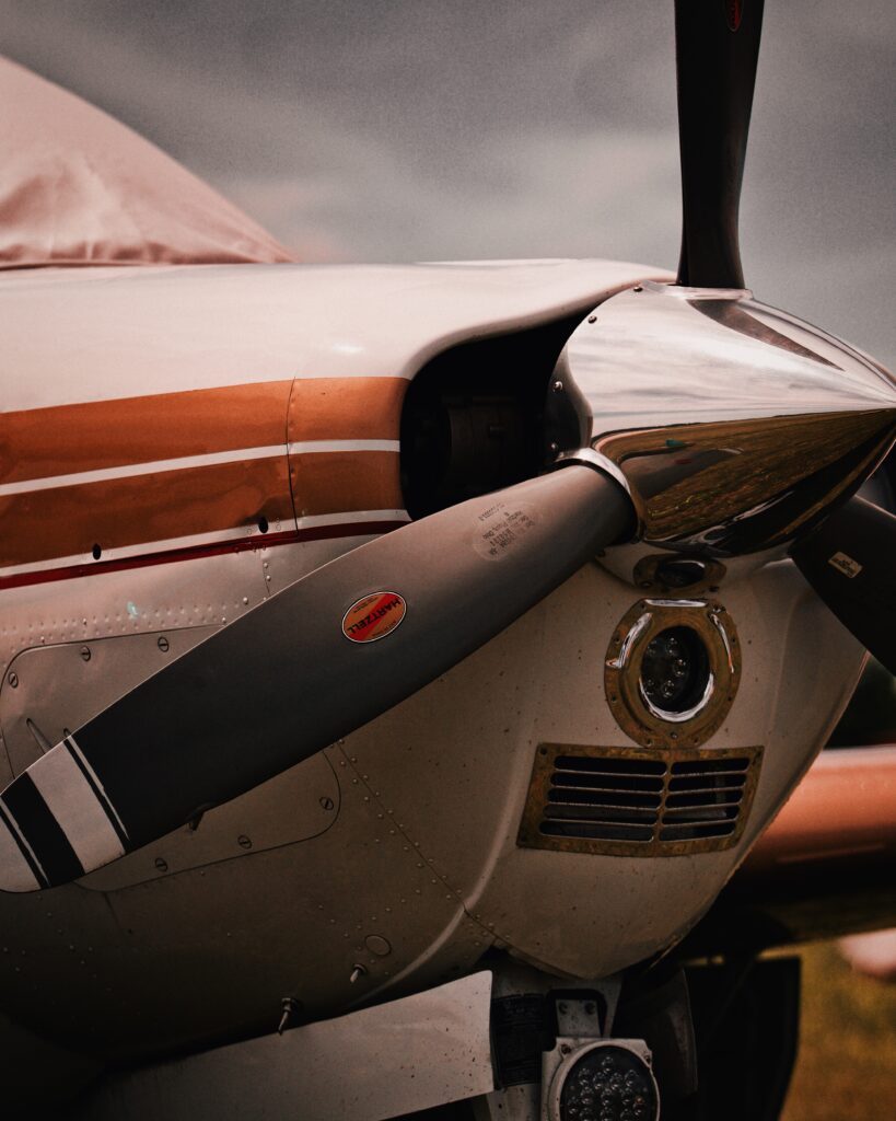Polished propeller and cowling on a parked single-engine airplane — brightwork is hand-finished metal work unique to aviation detailing
