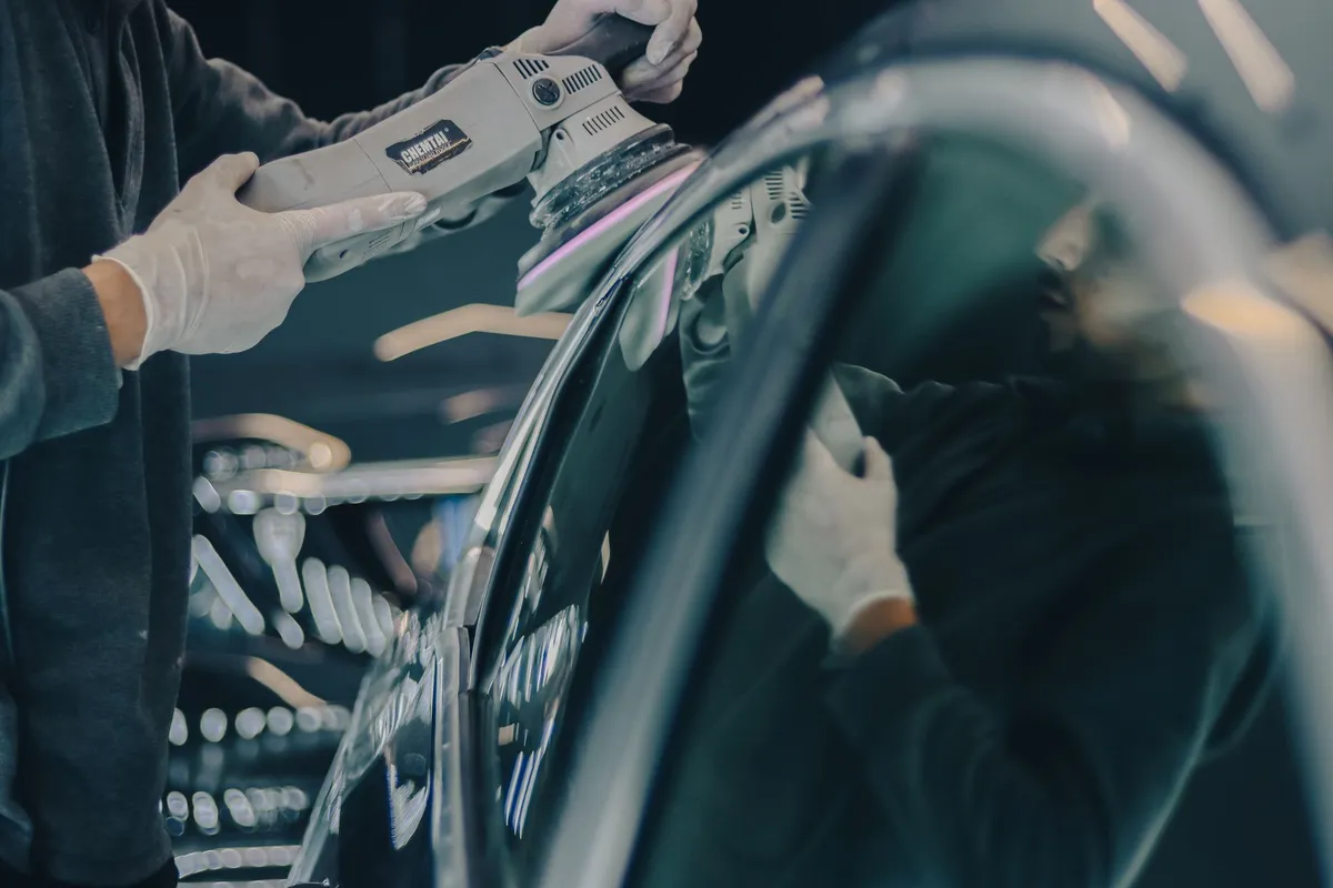 Machine-polishing a panel during coating prep — most of a ceramic install is labor before the coating ever opens