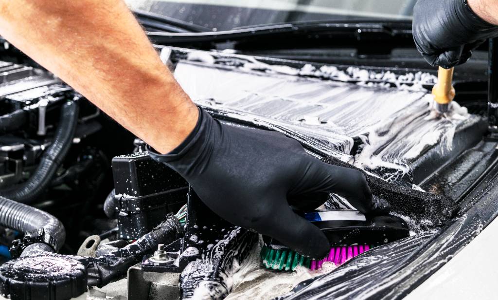 Engine Bay or a white car being cleaned and detailed